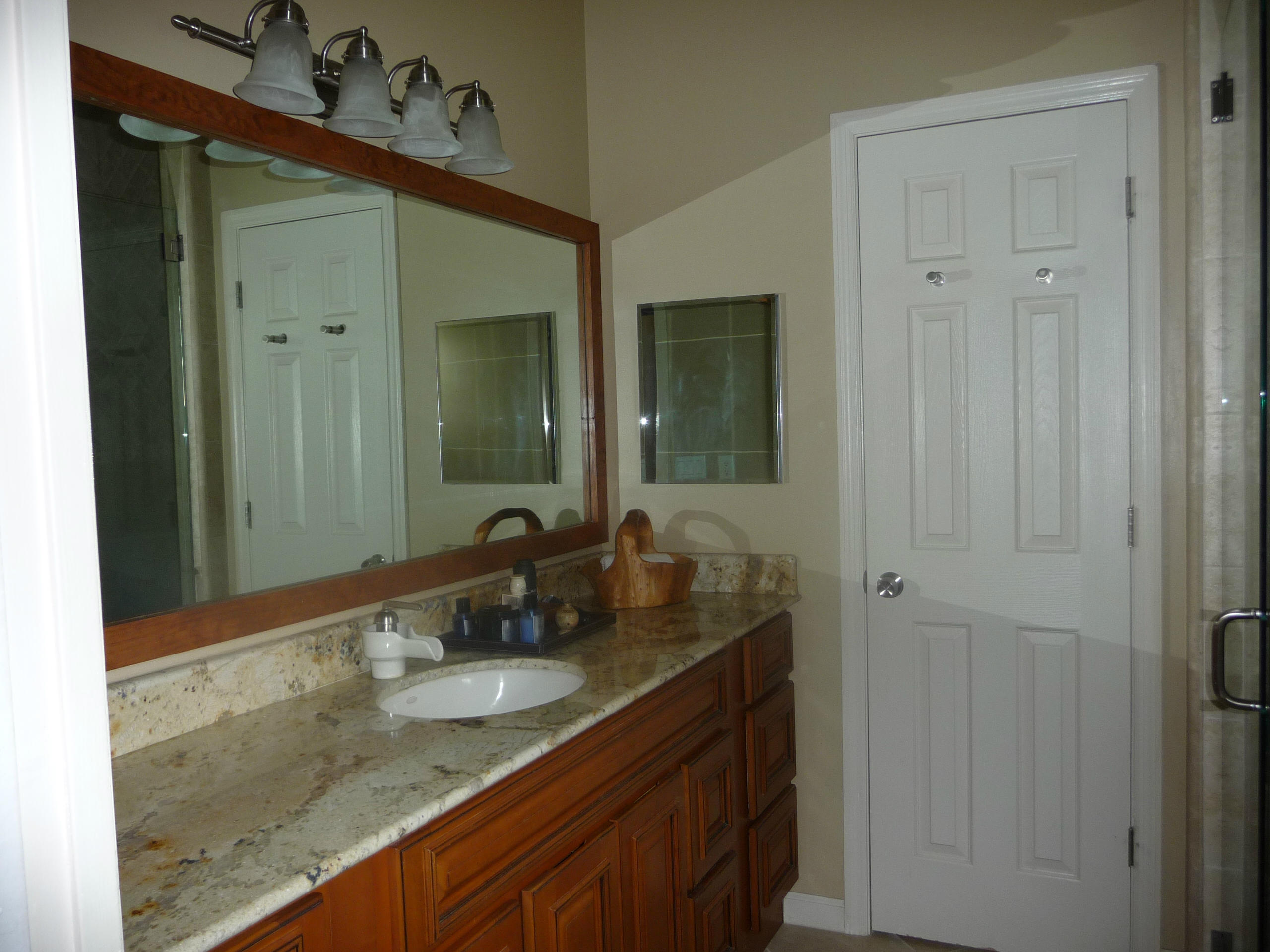 19655 118th Trail South, Unit FRNT Boca Raton, FL 33498 - Photo 8 of 31 a bathroom with a granite countertop sink and a mirror