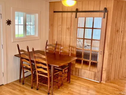 a view of a dining room with furniture and a window
