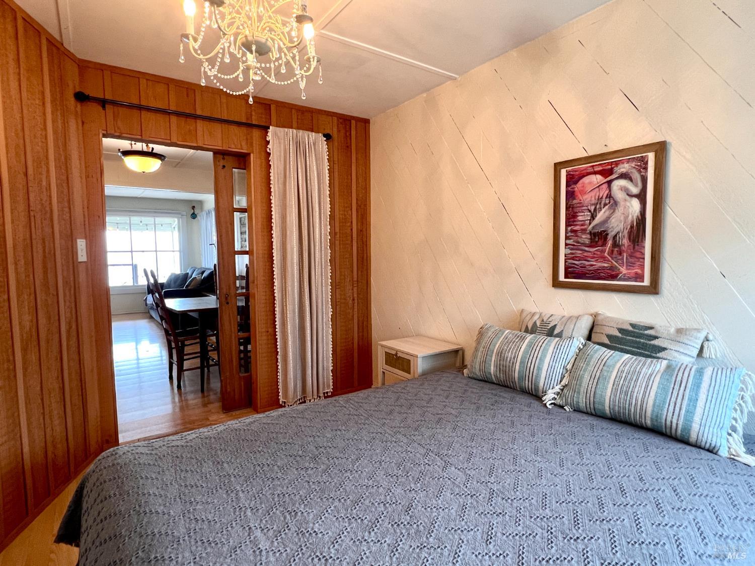 75 Ocean View Avenue Dillon Beach, CA 94929 - Photo 12 of 30 a bedroom with furniture and a chandelier