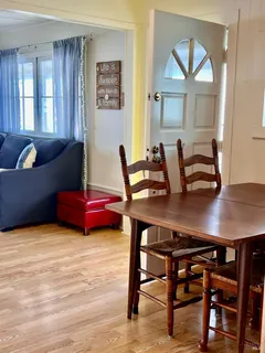 a view of a dining room with furniture and window