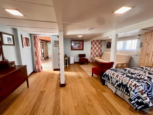 a spacious bedroom with a bed couch and a dresser