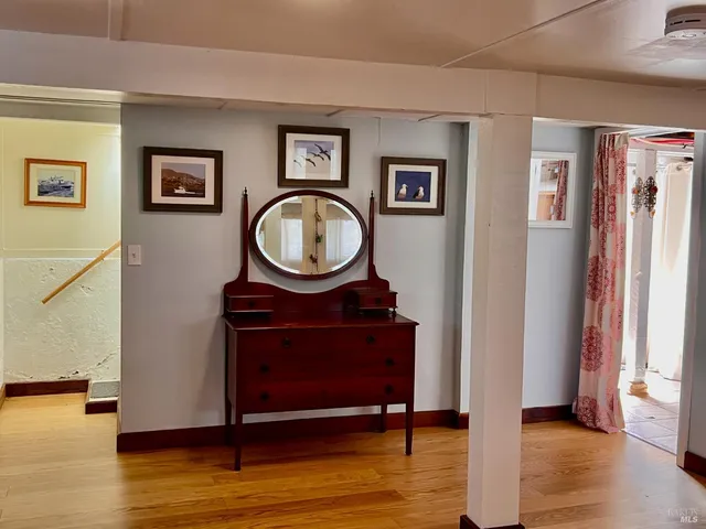 a view of a livingroom with furniture and a mirror