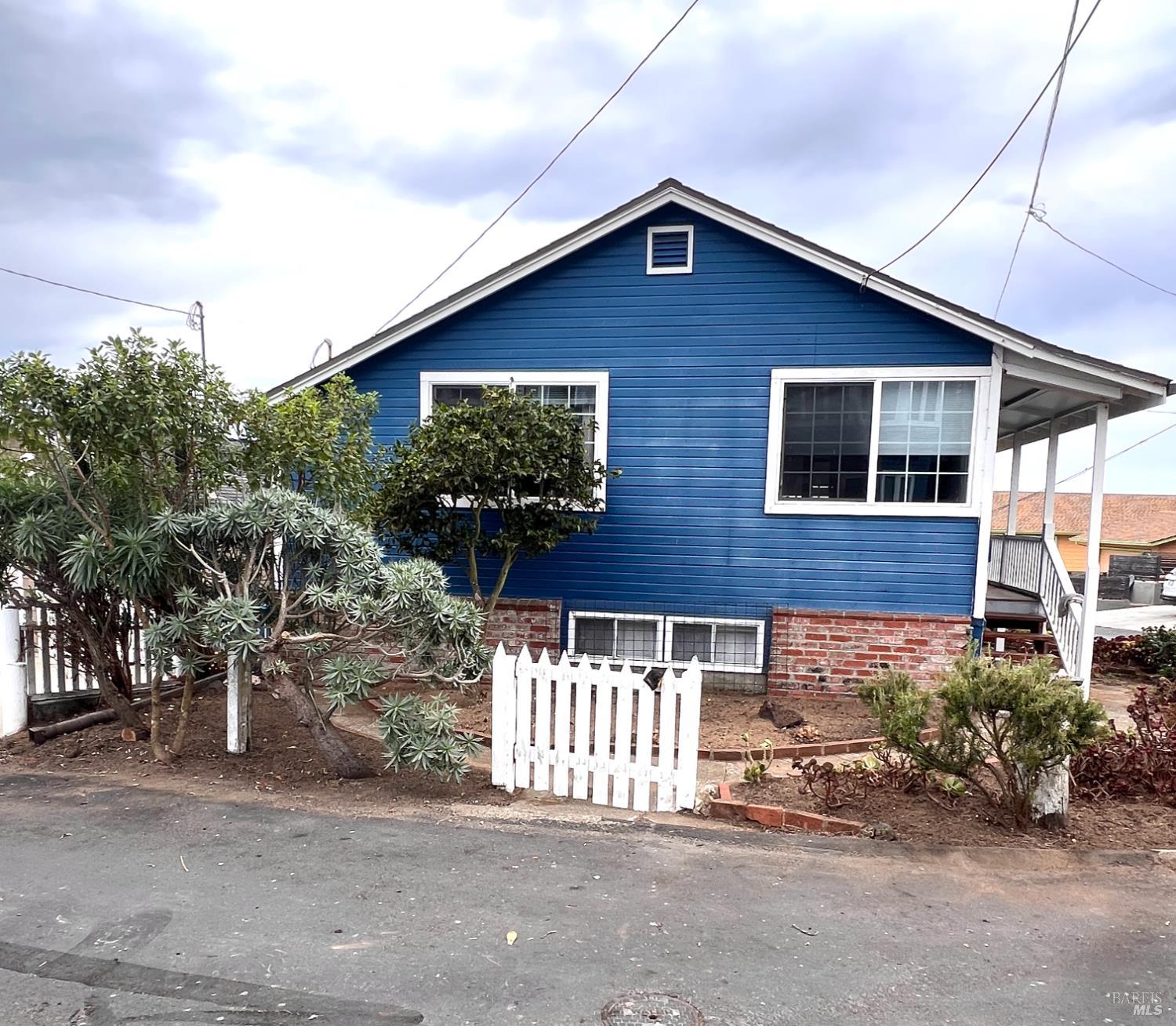 75 Ocean View Avenue Dillon Beach, CA 94929 - Photo 24 of 30 a front view of a house with a yard