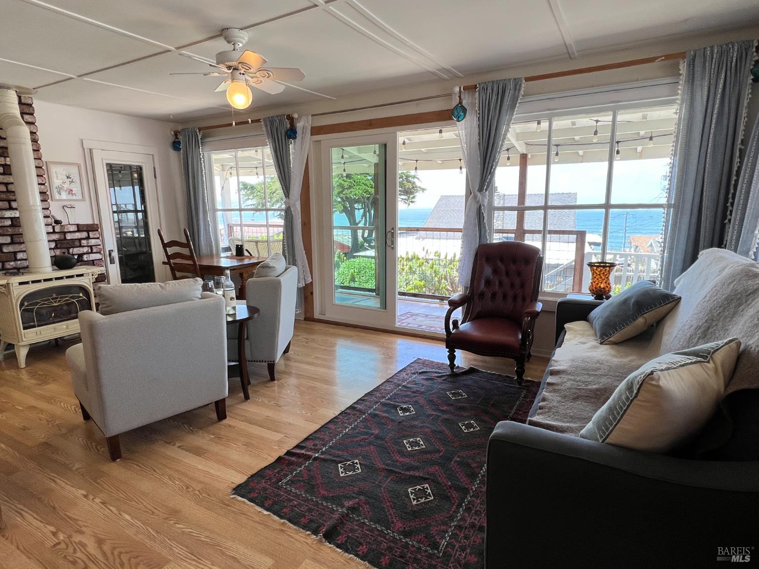 75 Ocean View Avenue Dillon Beach, CA 94929 - Photo 26 of 30 a living room with furniture and a floor to ceiling window