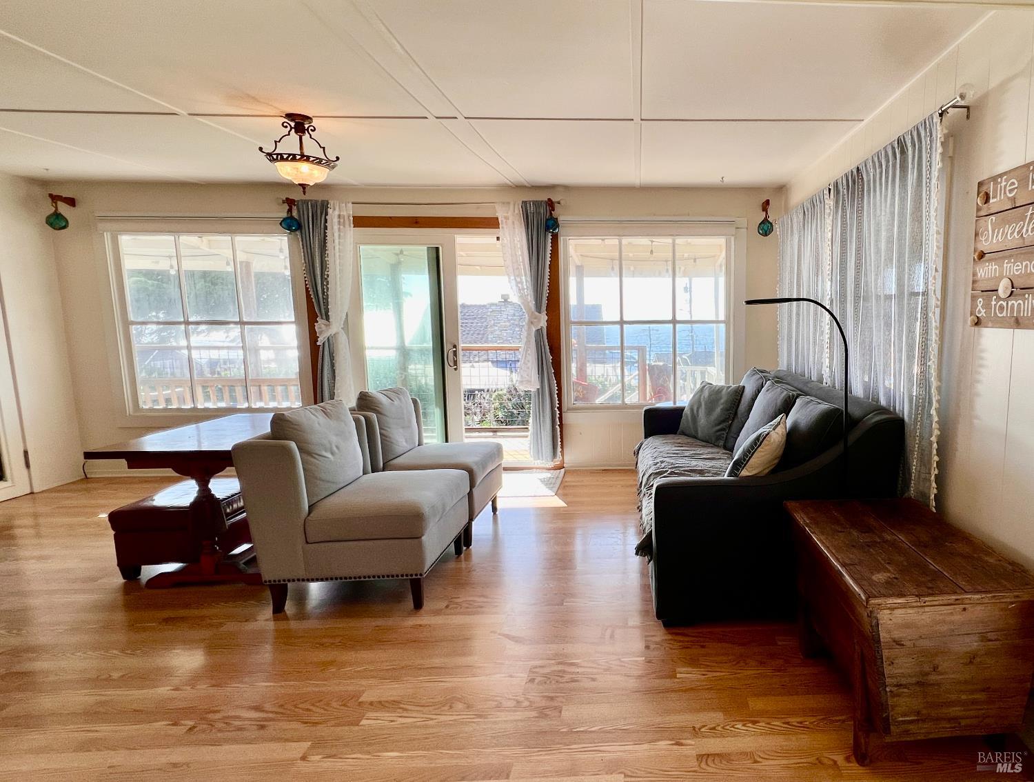75 Ocean View Avenue Dillon Beach, CA 94929 - Photo 3 of 30 a living room with furniture and a large window