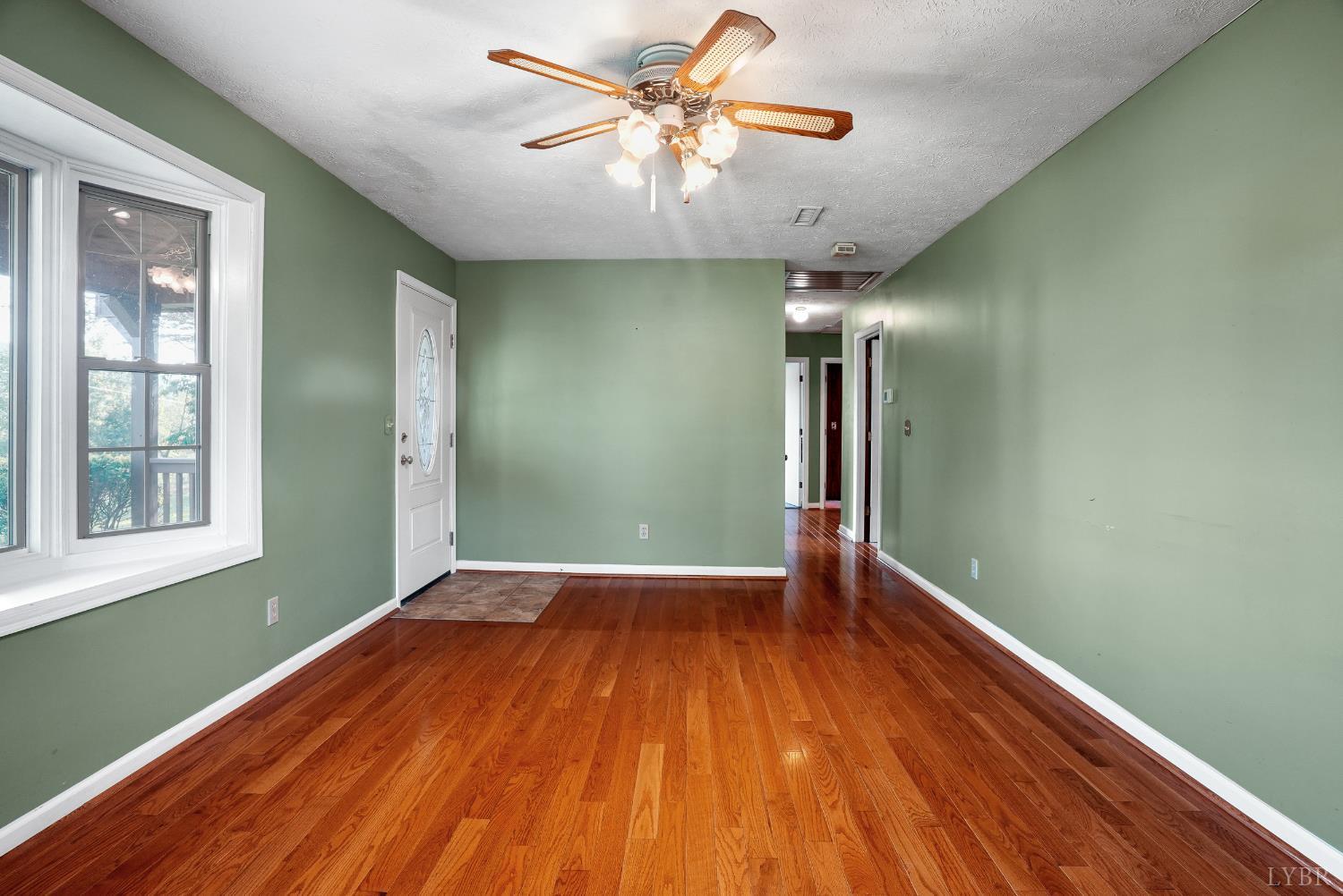 2294 High Peak Road Monroe, VA 24574 - Photo 12 of 53 a view of empty room with wooden floor and fan