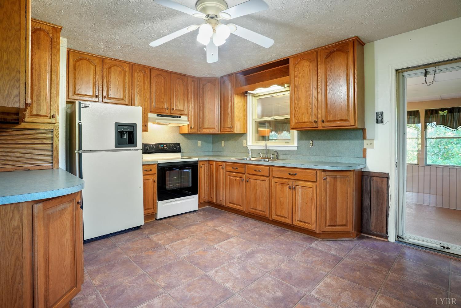 2294 High Peak Road Monroe, VA 24574 - Photo 13 of 53 a kitchen with stainless steel appliances granite countertop a stove a sink dishwasher a refrigerator and a microwave oven