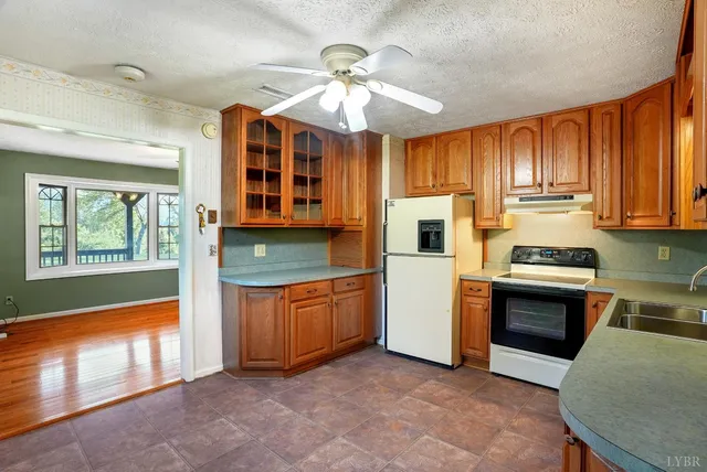 a view of a kitchen with wooden cabinets