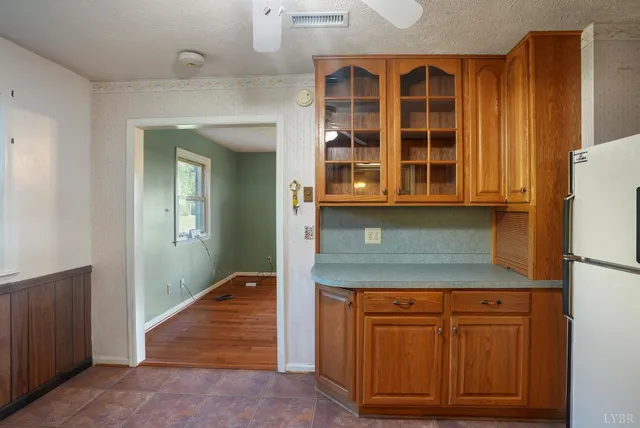 a kitchen with stainless steel appliances granite countertop wooden cabinets a sink and a granite counter
