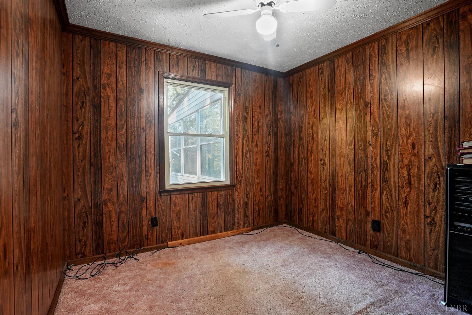 2294 High Peak Road Monroe, VA 24574 - Photo 21 of 53 an empty room with windows chandelier fan and hallway