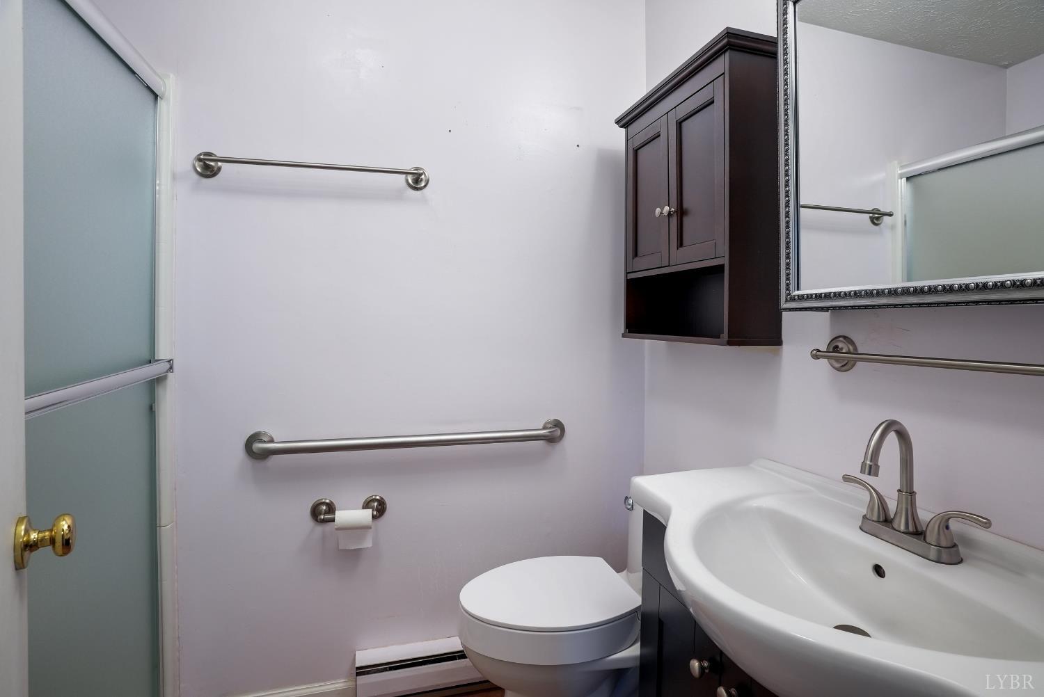 2294 High Peak Road Monroe, VA 24574 - Photo 25 of 53 a bathroom with a sink a toilet and a mirror