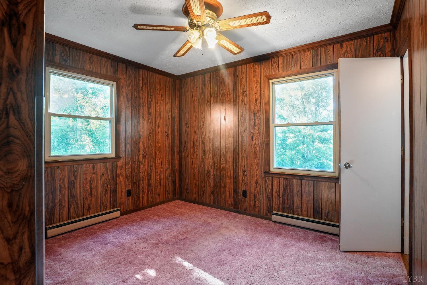 2294 High Peak Road Monroe, VA 24574 - Photo 26 of 53 an empty room with windows and fan