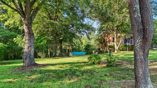 an aerial view of a house with yard swimming pool and outdoor seating