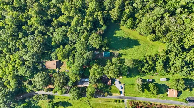 a view of a houses with a lush green hillside