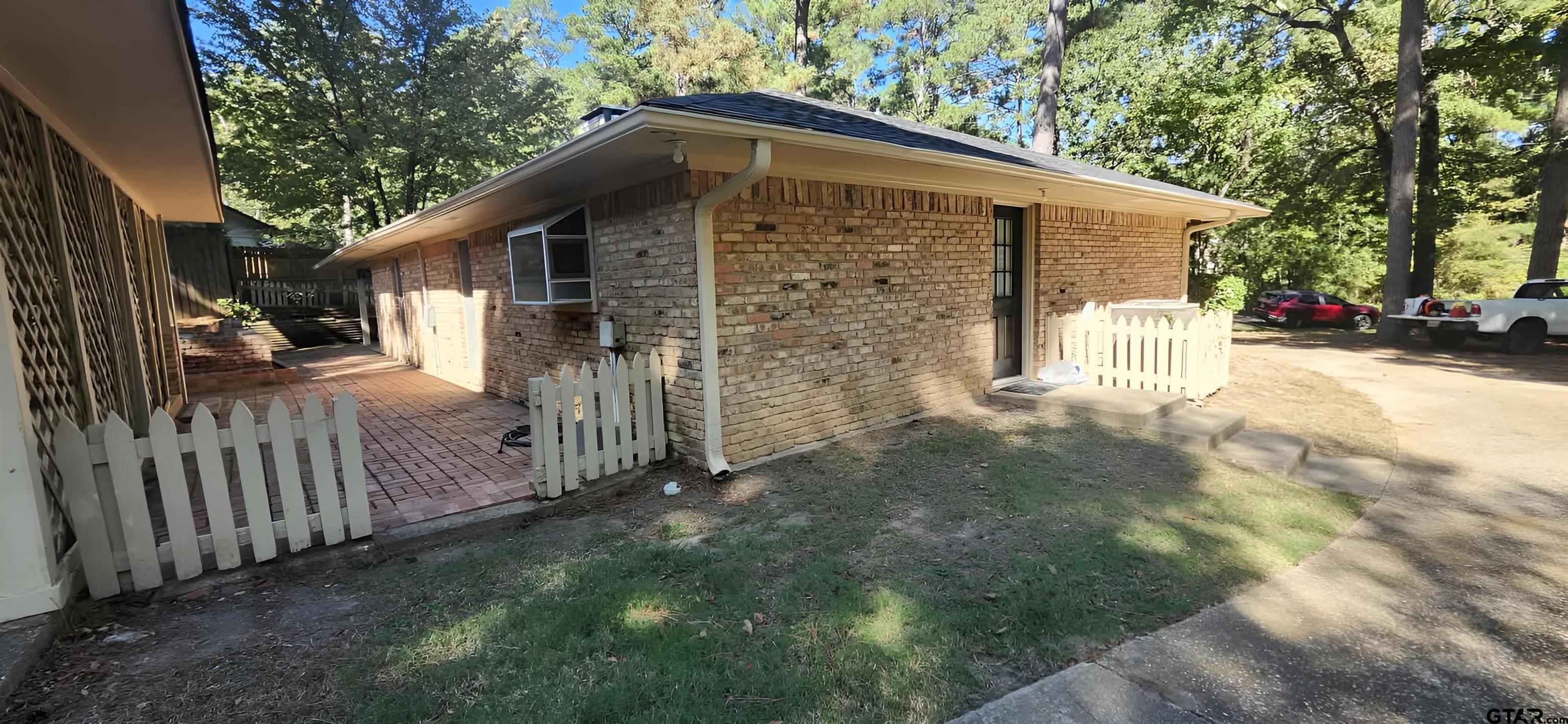 14141 County Road 1237 Tyler, TX 75703 - Photo 12 of 15 a view of a small house with wooden fence