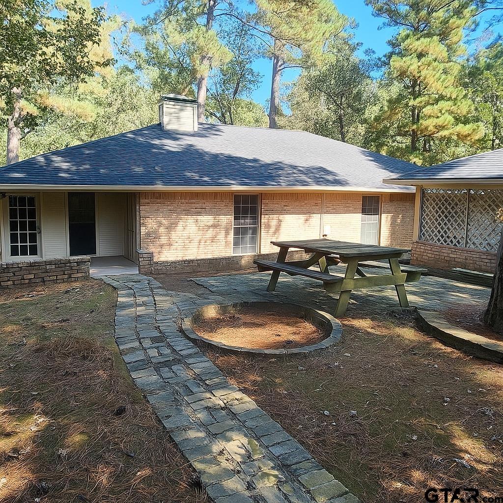14141 County Road 1237 Tyler, TX 75703 - Photo 13 of 15 a backyard of a house with yard fire pit and outdoor seating