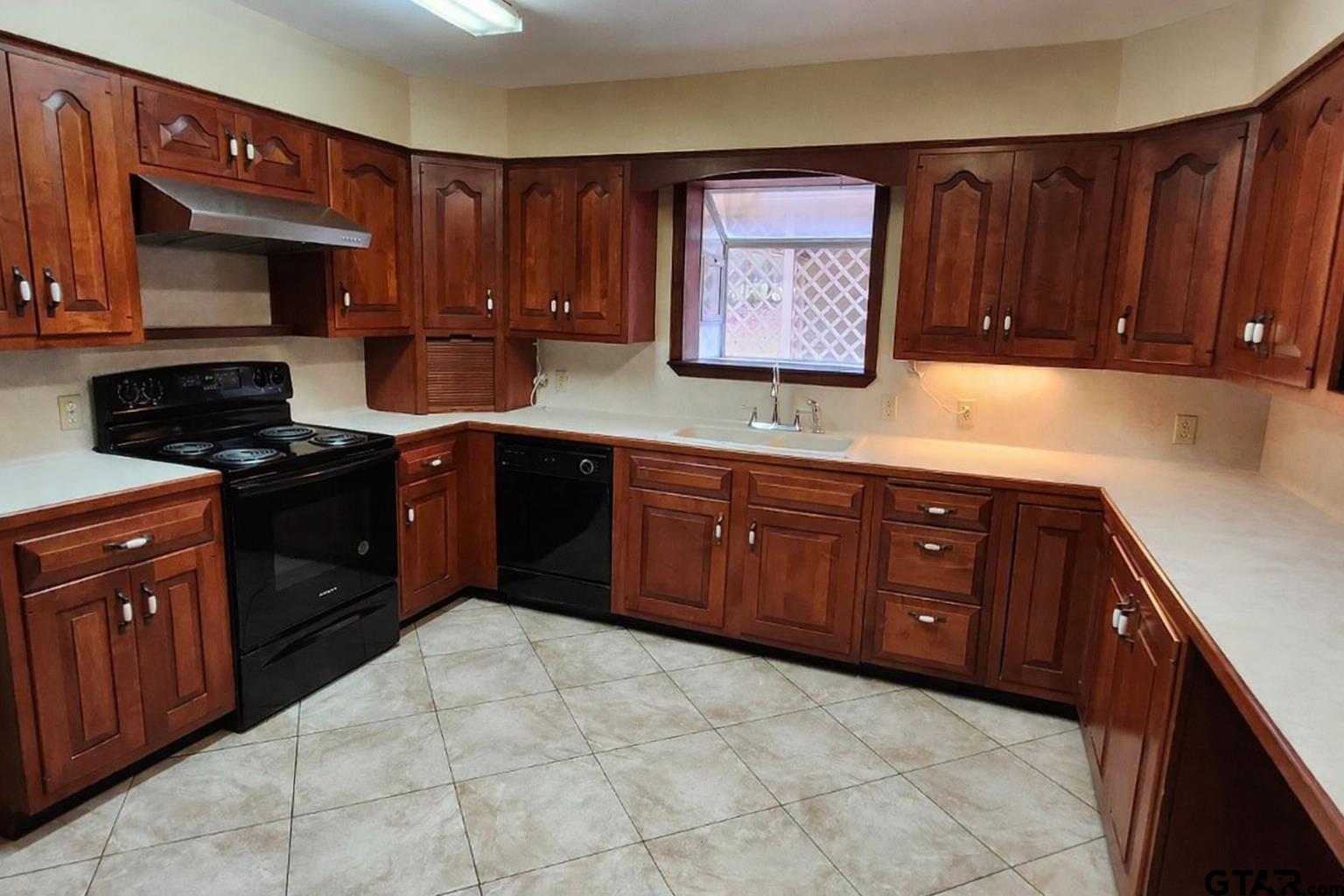 14141 County Road 1237 Tyler, TX 75703 - Photo 3 of 19 a kitchen with stainless steel appliances granite countertop a stove sink and cabinets