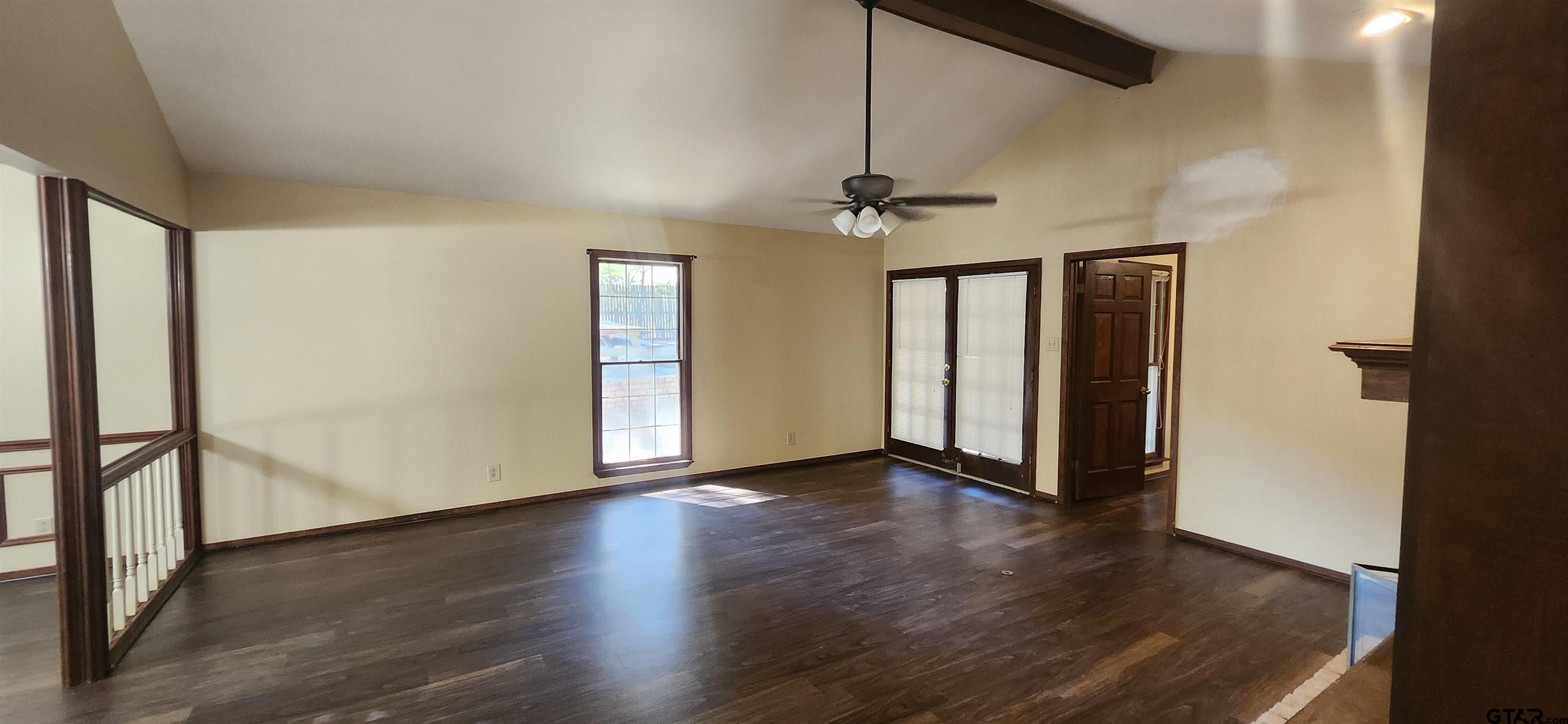 14141 County Road 1237 Tyler, TX 75703 - Photo 4 of 15 an empty room with wooden floor chandelier and windows