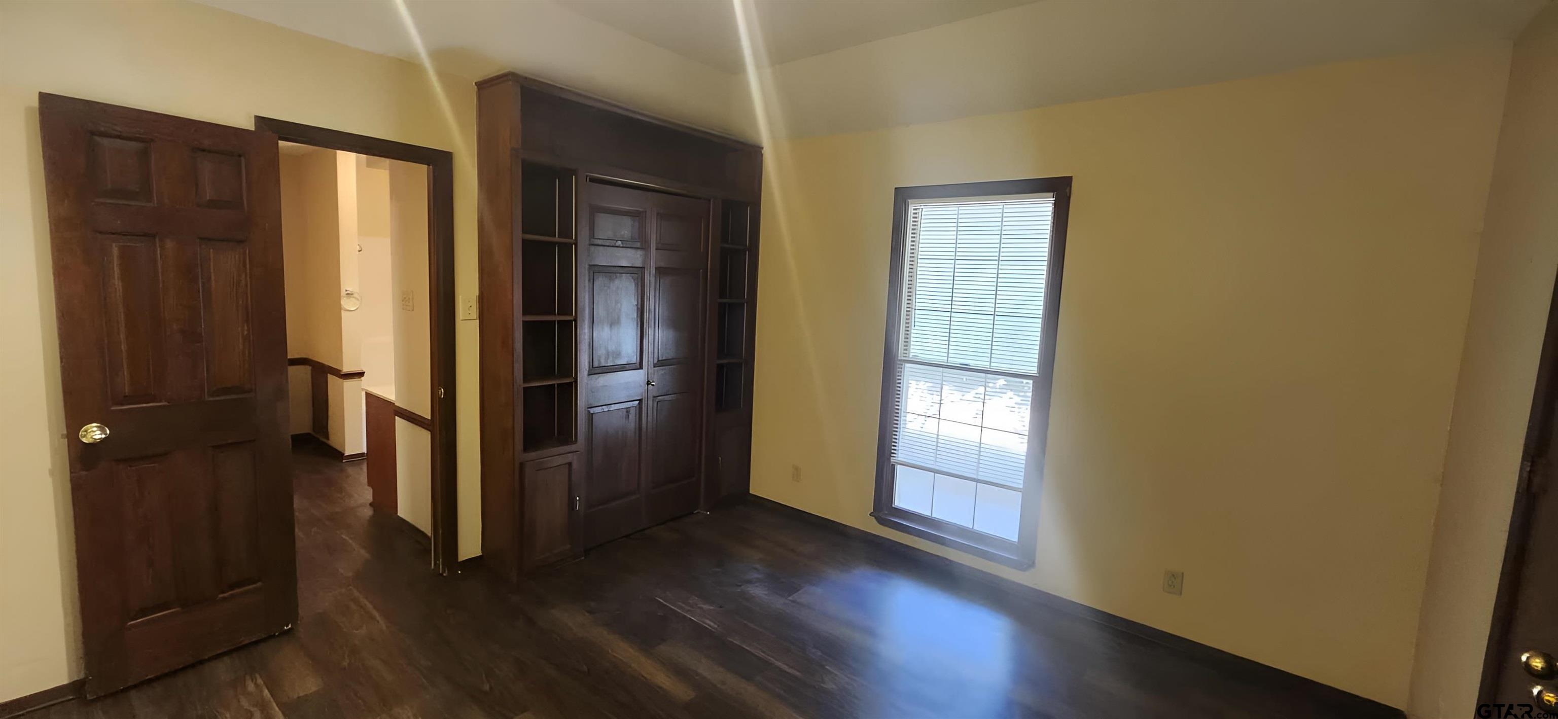 14141 County Road 1237 Tyler, TX 75703 - Photo 9 of 19 an empty room with wooden floor and a window
