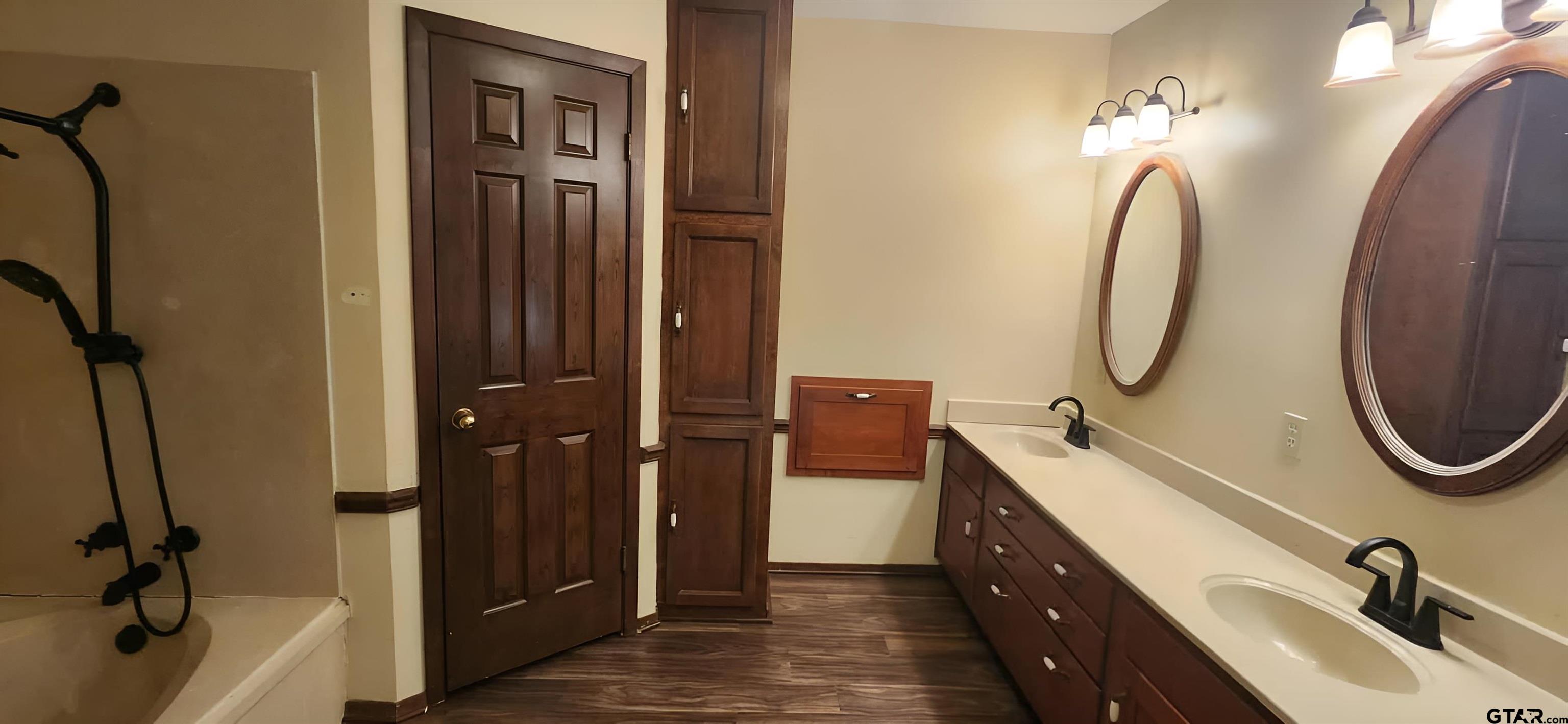 14141 County Road 1237 Tyler, TX 75703 - Photo 9 of 15 a en suite bathroom with a double vanity sink a mirror and a shower