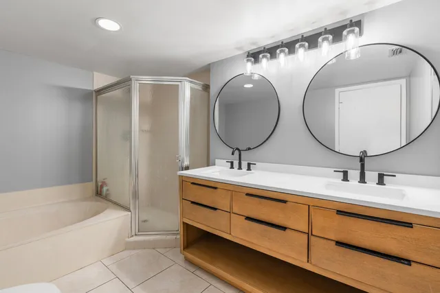 a bathroom with a double vanity sink and a mirror