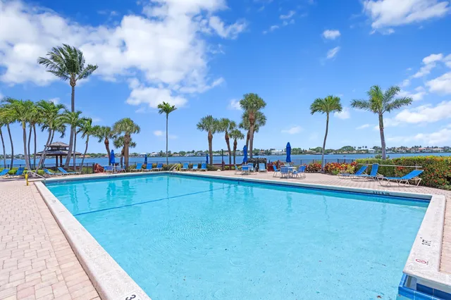 an aerial view of a house with a garden and lake view