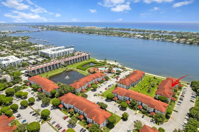 an aerial view of lake and residential houses with outdoor space