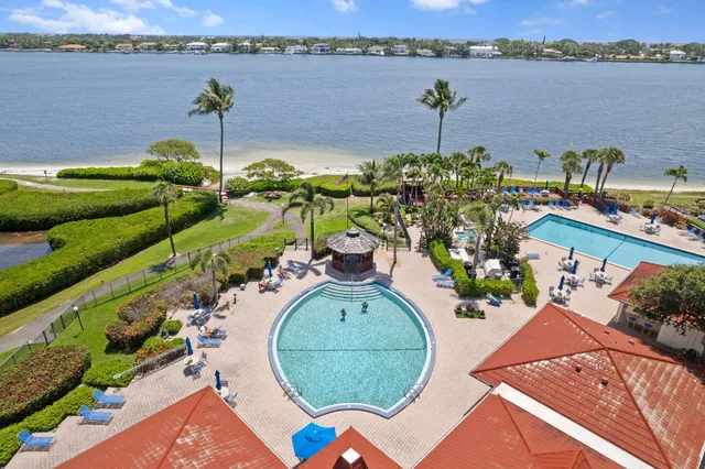an aerial view of a house with a yard and lake view