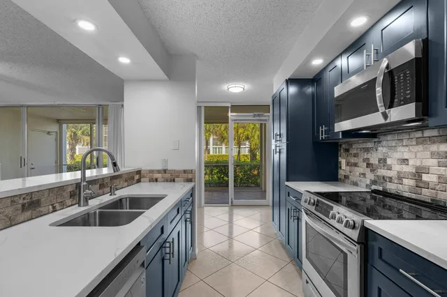 a kitchen that has a sink and a stove