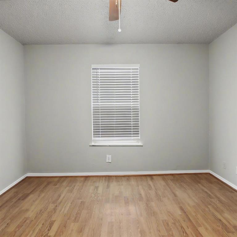 2511 West Prairie Street Denton, TX 76201 - Photo 9 of 10 a view of an empty room with wooden floor and a window