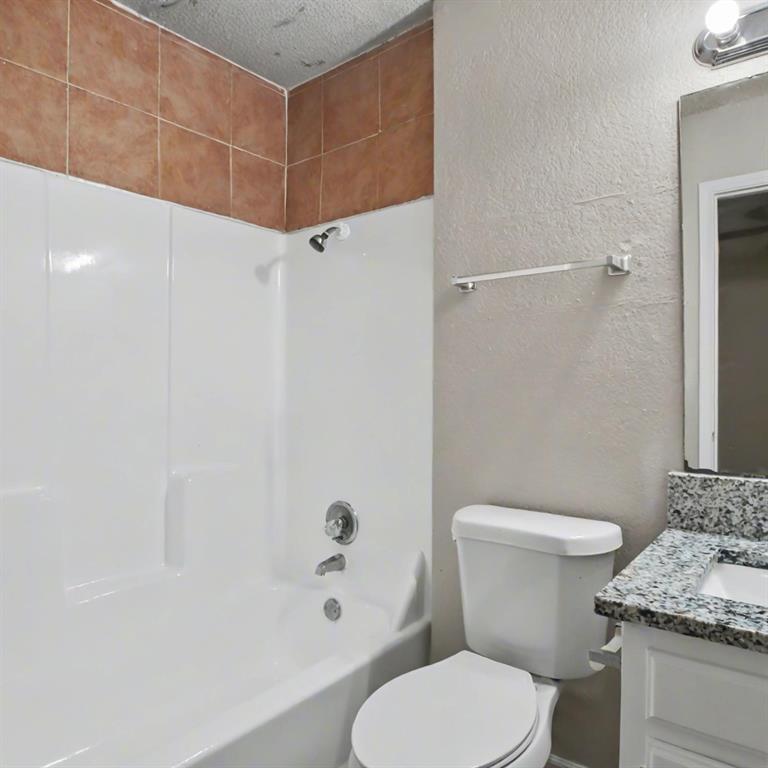 2511 West Prairie Street Denton, TX 76201 - Photo 10 of 10 a white toilet sitting next to a bathroom sink