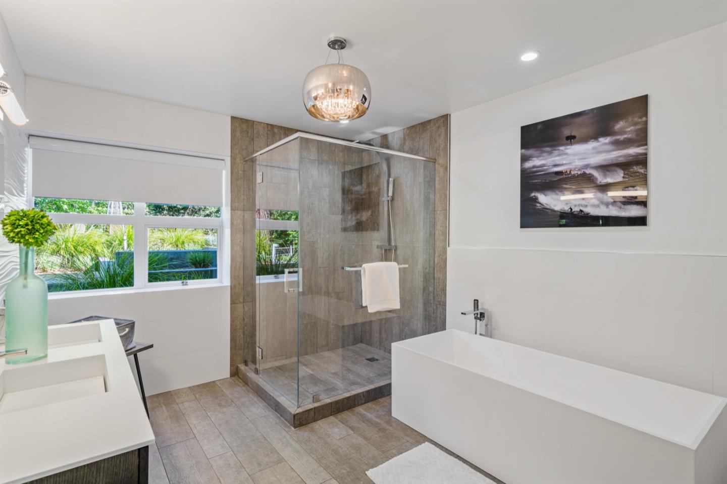 135 Willowbrook Drive Portola Valley, CA 94028 - Photo 26 of 50 a bathroom with a bathtub and a chandelier