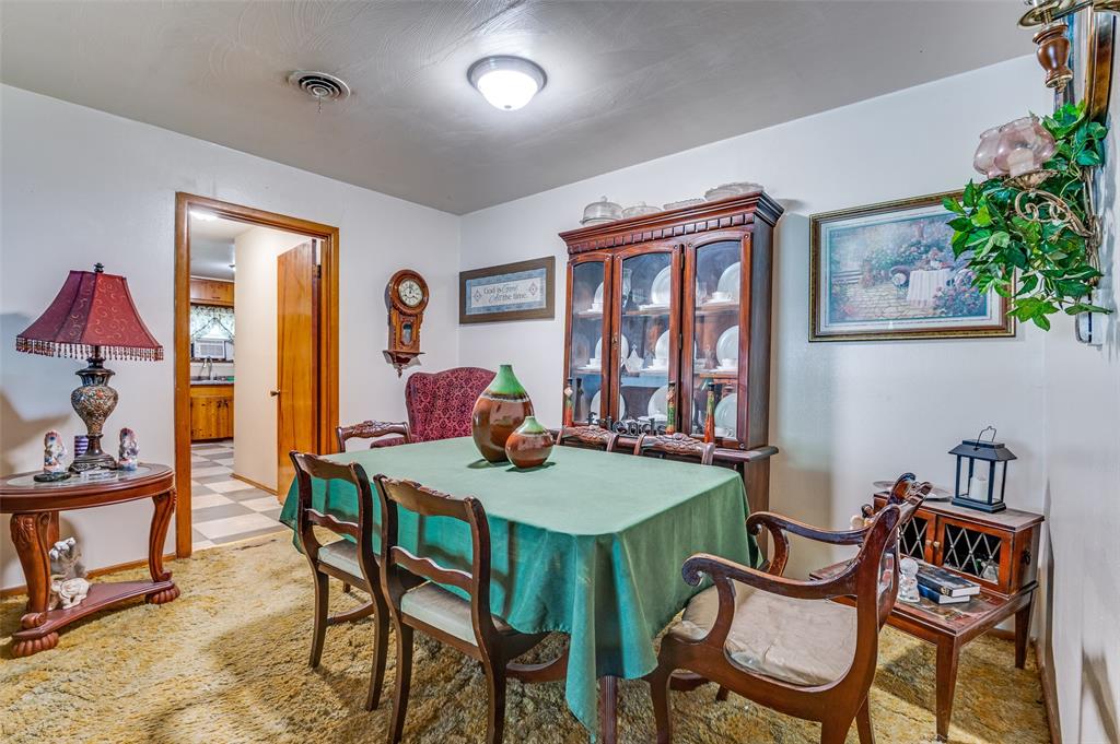 1447 Gillette Street Dallas, TX 75217 - Photo 3 of 12 a view of a dining room with furniture and a potted plant