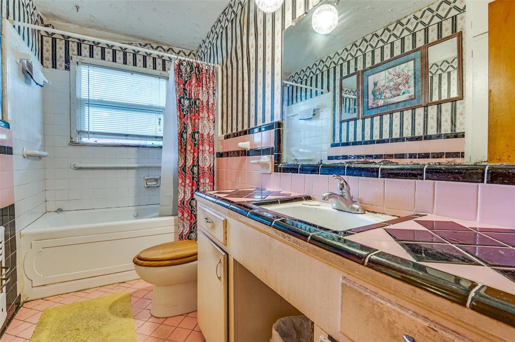 1447 Gillette Street Dallas, TX 75217 - Photo 8 of 12 a bathroom with a granite countertop sink a toilet and bathtub