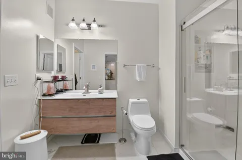 a bathroom with a toilet a sink and a mirror