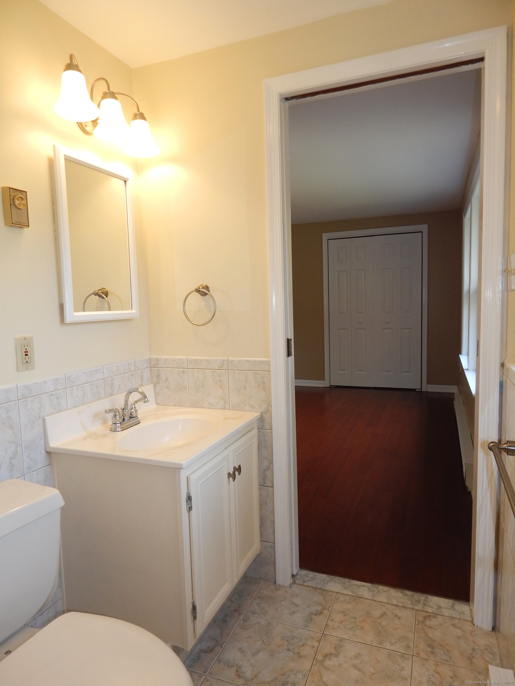 62 Bascom Road Lebanon, CT 06249 - Photo 24 of 34 a bathroom with a toilet sink and mirror