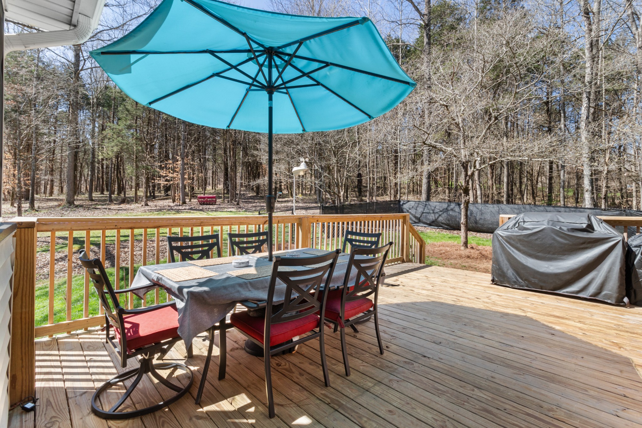 340 Batson Road Cunningham, TN 37052 - Photo 33 of 57 a view of a roof deck with table and chairs under an umbrella