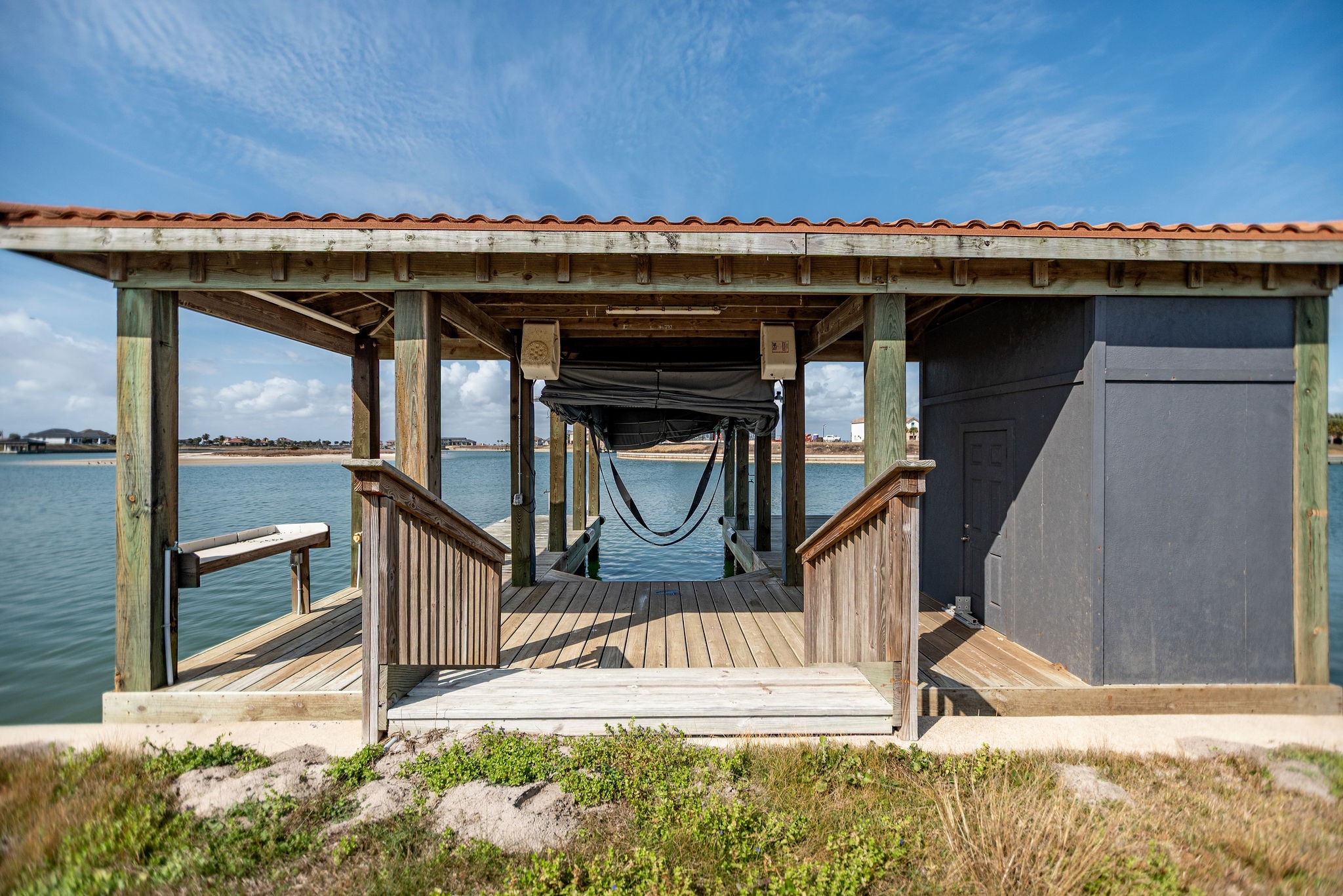 154 Chateau Way Port Port O'Connor, TX 77982 - Photo 3 of 16 Single Stall Boathouse with remote touchless boat cover, fishing deck, storage room, and fish cleaning table