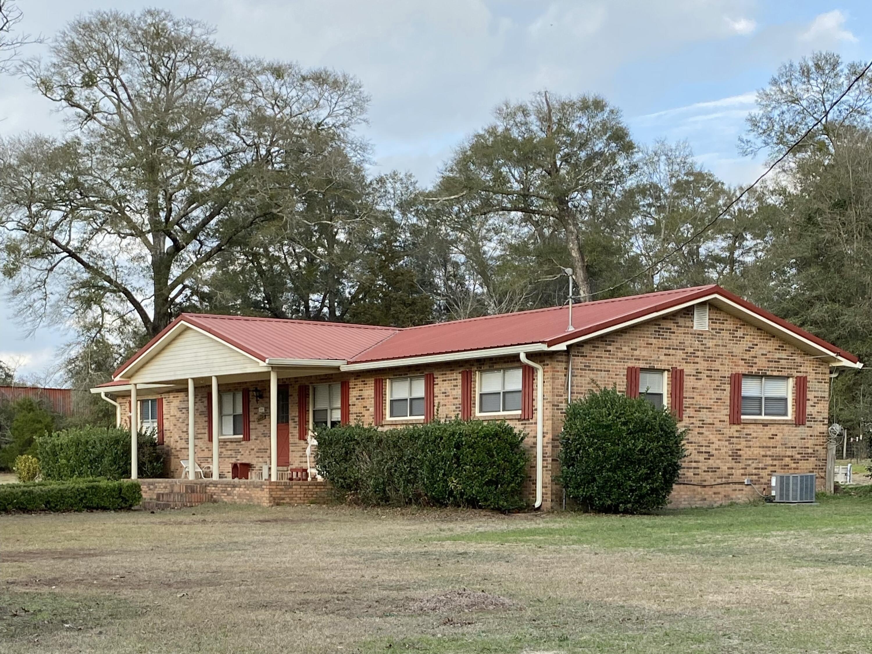 186 McLaughlin Road Milton, FL 32570 - Photo 2 of 26 a front view of a house with a yard