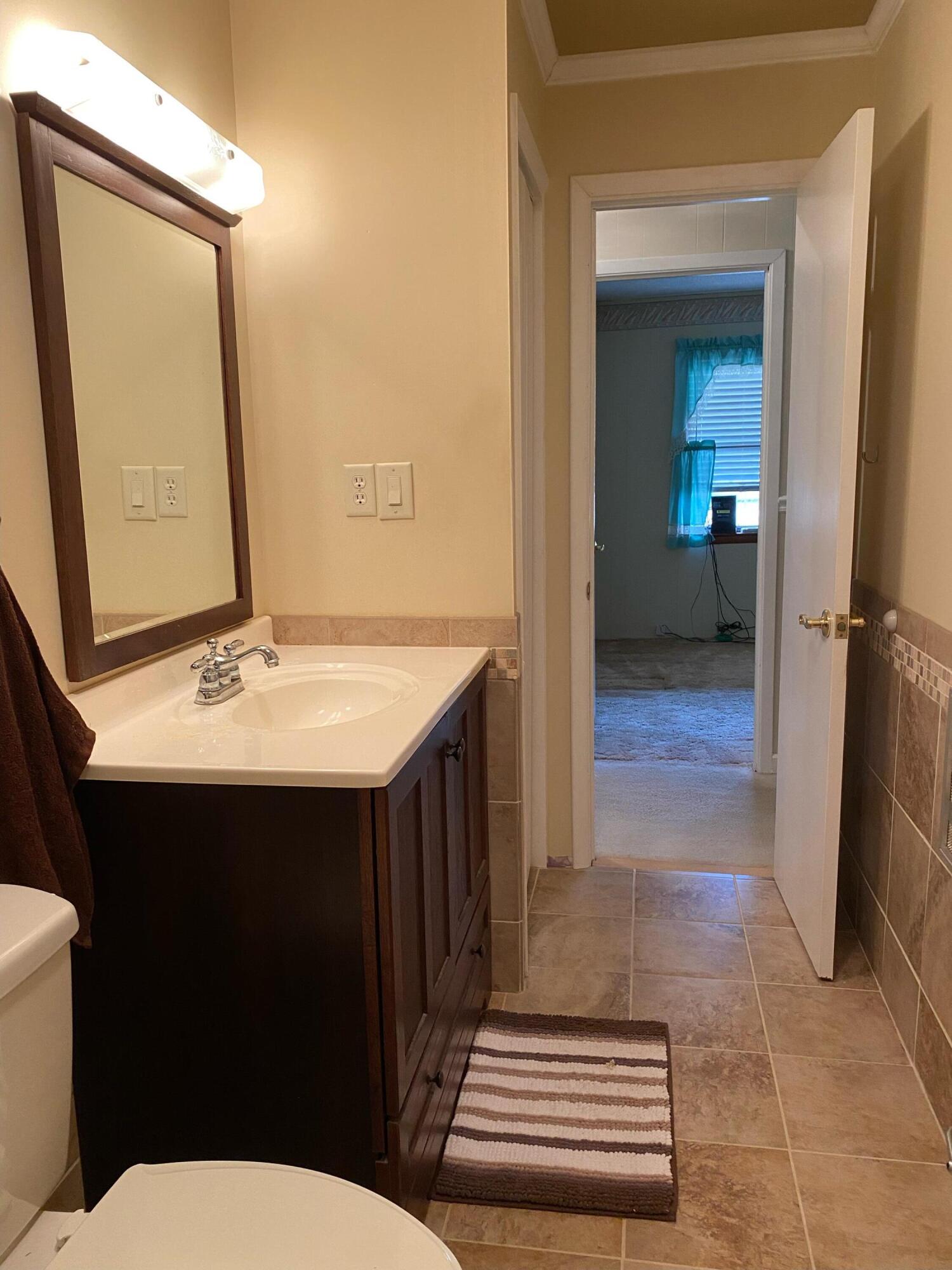 186 McLaughlin Road Milton, FL 32570 - Photo 21 of 26 a bathroom with a sink and a mirror