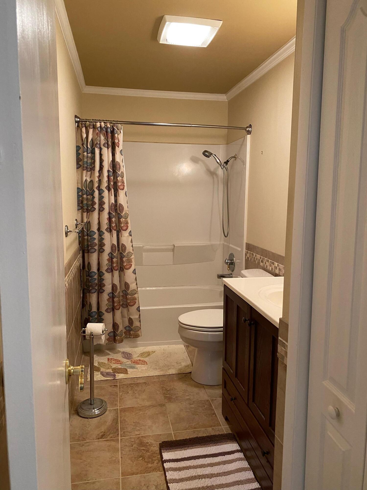 186 McLaughlin Road Milton, FL 32570 - Photo 22 of 26 a bathroom with a granite countertop sink toilet and shower