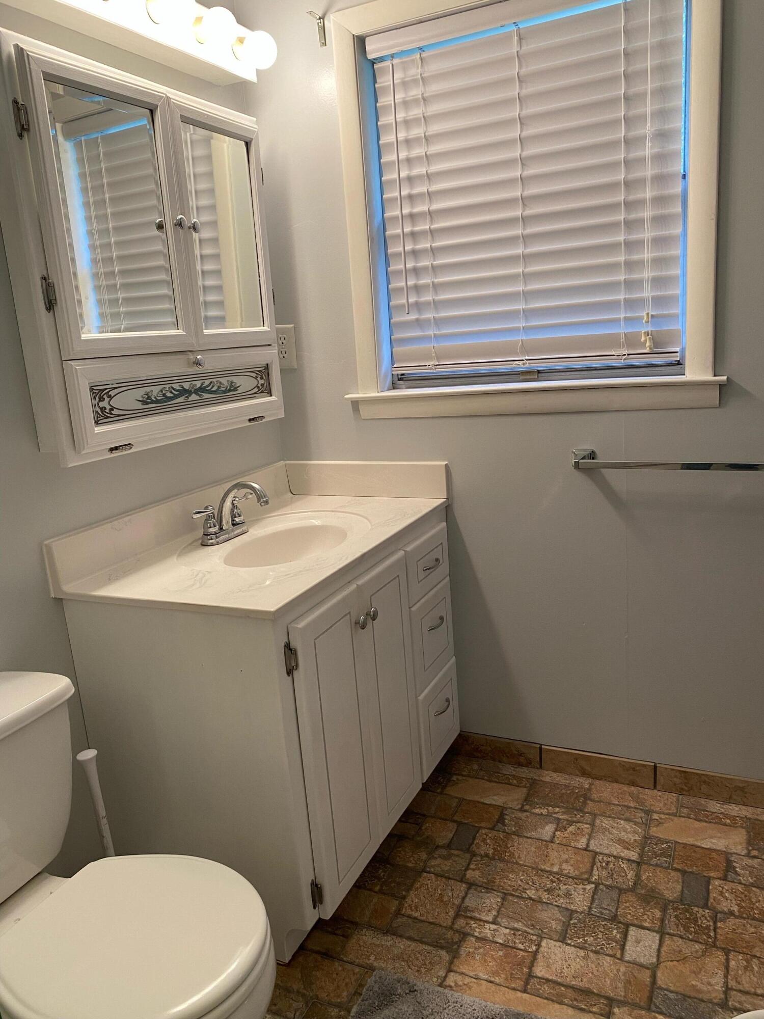 186 McLaughlin Road Milton, FL 32570 - Photo 25 of 26 a bathroom with a sink a toilet and a mirror