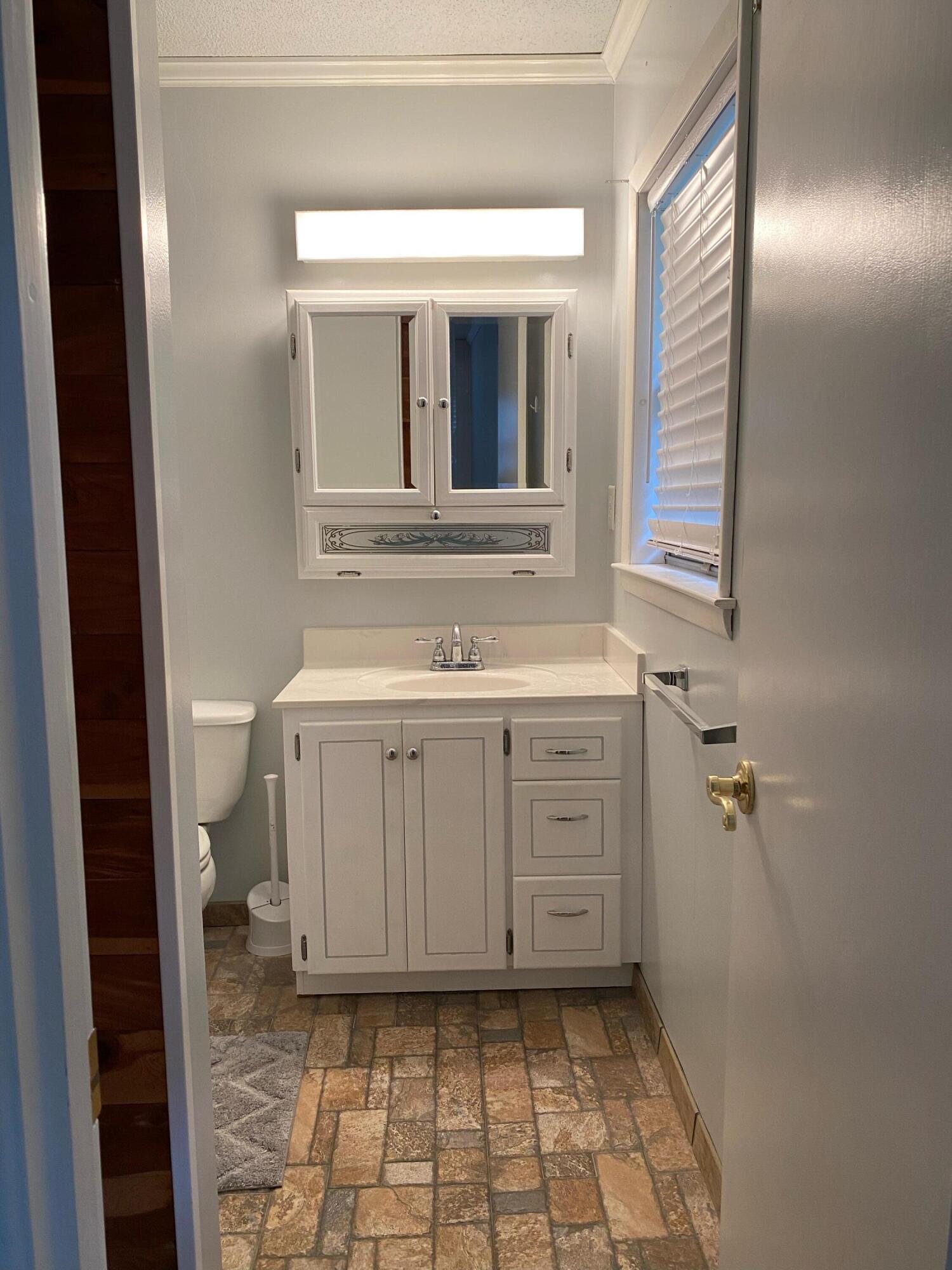 186 McLaughlin Road Milton, FL 32570 - Photo 26 of 26 a bathroom with a sink a toilet and a mirror