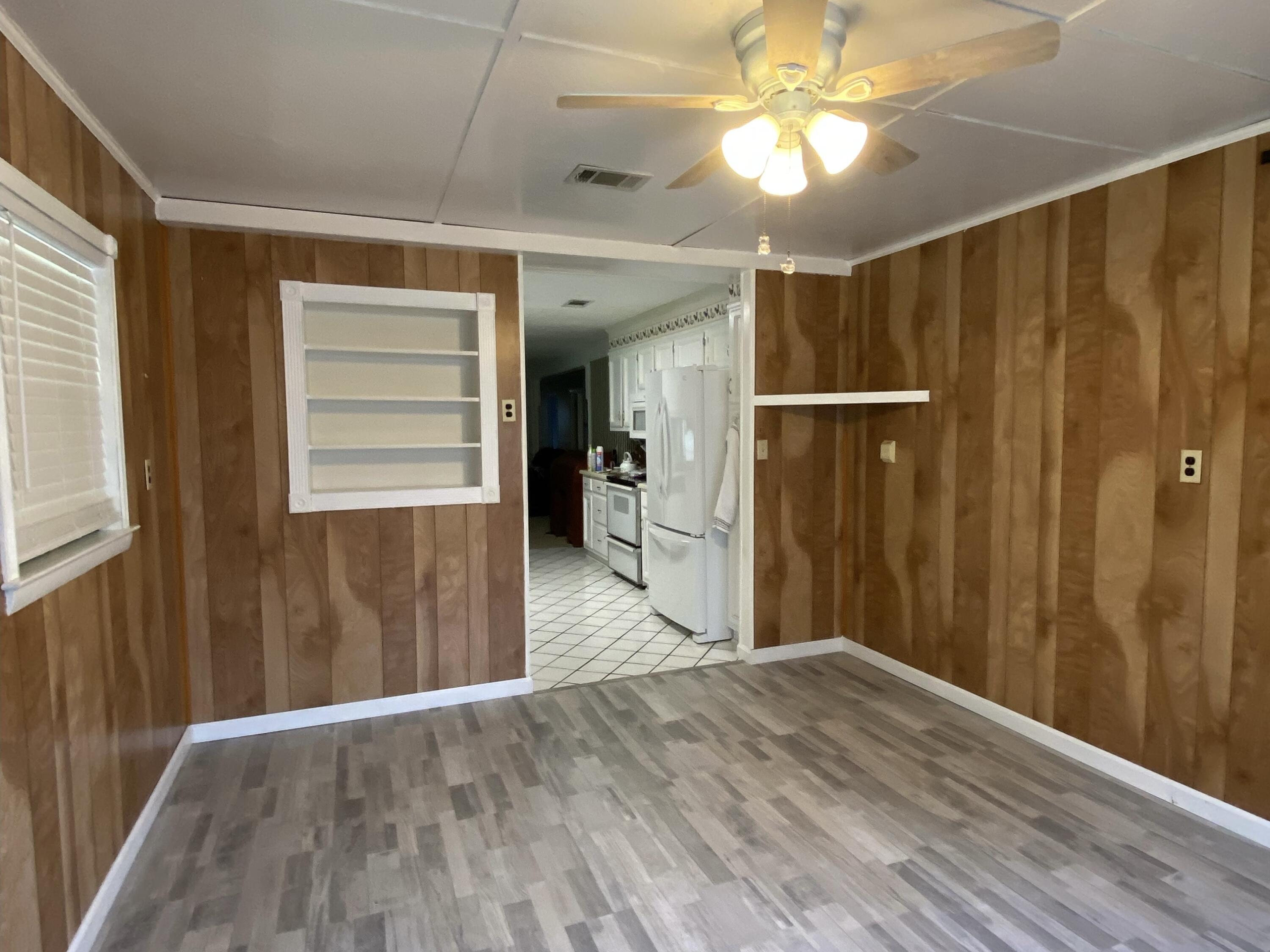 186 McLaughlin Road Milton, FL 32570 - Photo 7 of 26 a view of empty room with wooden floor