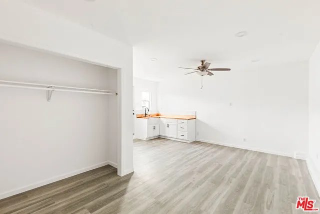 a view of a room with wooden floor