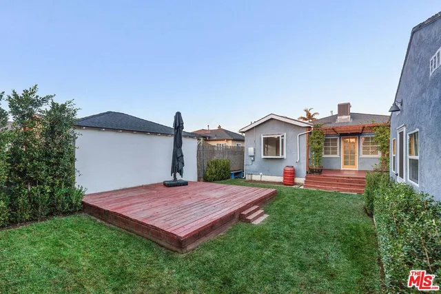 a view of a house with a yard and fence