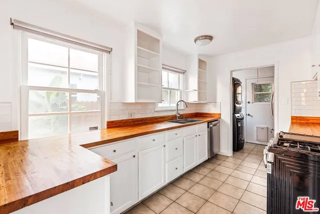 a kitchen with granite countertop a sink and a stove top oven