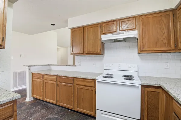 a kitchen with stainless steel appliances granite countertop a sink stove and cabinets