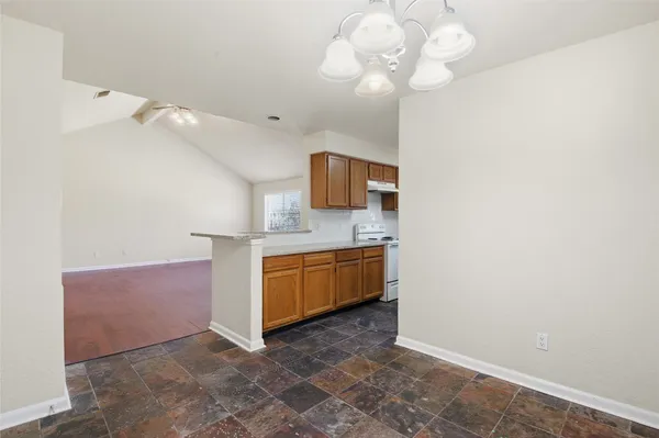 a spacious bathroom with a granite countertop sink a mirror and vanity