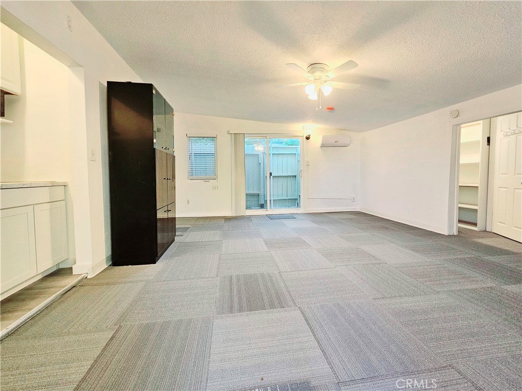 7513 Lurline Avenue Winnetka, CA 91306 - Photo 3 of 9 a view of an empty room with window and chandelier fan